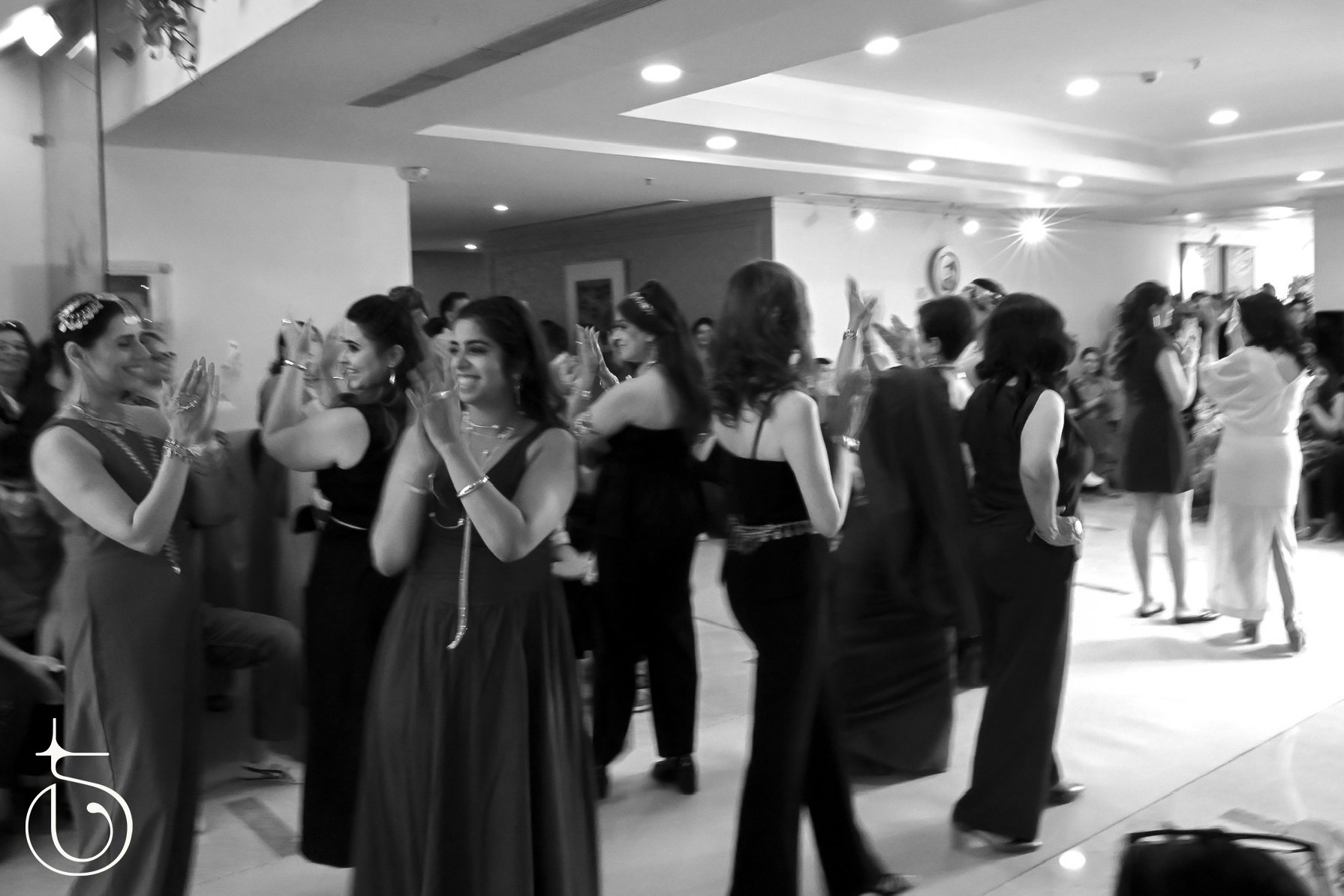 Women wearing Thingalicious jewelry clap as they walk through the audience.